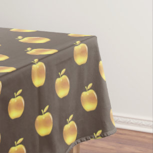 Gouden appels op bruine tafelkleed