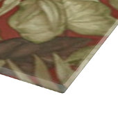 Gouden bladeren op rode snijplank (Hoek)