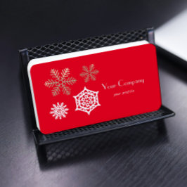 gouden en witte sneeuwvlokken tegen rood visitekaartje
