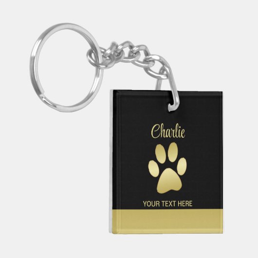 Gouden glanzende hondenpoot op zwarte achtergrond sleutelhanger (Voorkant Links)