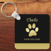 Gouden glanzende hondenpoot op zwarte achtergrond sleutelhanger (Voorkant)
