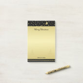 Gouden glanzende kerststerren, poten op goud & zwa post-it® notes (Op bureau)