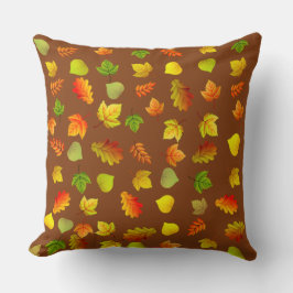 Gouden, groene, oranje herfstbladeren op bruin kussen