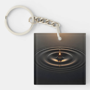 Gouden impact op het viskeuze oppervlak sleutelhanger
