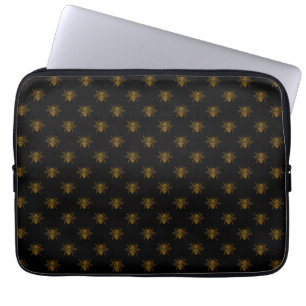 Gouden metalen folie bijen op zwart laptop sleeve