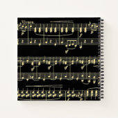 Gouden muziek op zwart notitieboek (Achterkant)