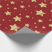 Gouden sterren op rode achtergrond cadeaupapier (Hoek)