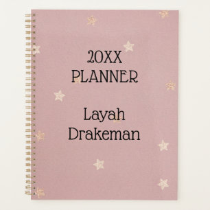 Gouden sterren op roze jaarlijks planner