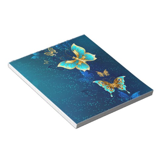 Gouden vlinders op een blauwe achtergrond notitieblok (Schuin)