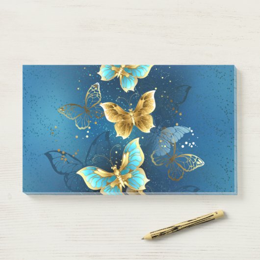 Gouden vlinders post-it® notes (Op bureau)