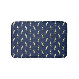 Gouden zeepaarden op marineblauw badmat