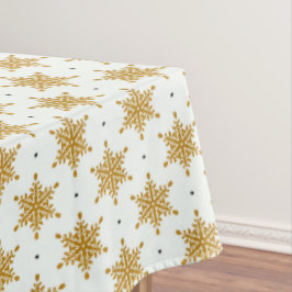 Goudsneeuwvlokken op de witte winter tafelkleed