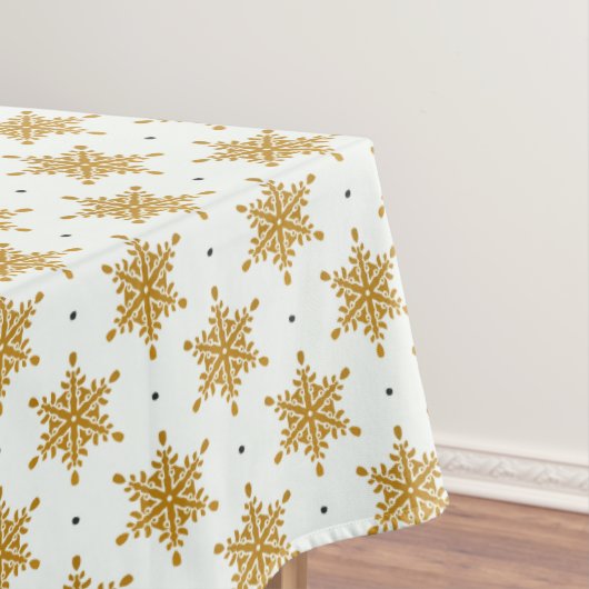 Goudsneeuwvlokken op de witte winter tafelkleed (Voorbeeld)