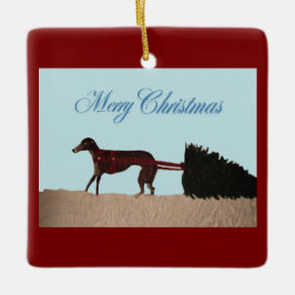 Greyhound trekt een kerstboom door de sneeuw keramisch ornament