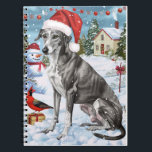 Greyhound Winter Wonderland Christmas Joy Notitieboek<br><div class="desc">Dit feestelijke ontwerp vangt de vrolijke sfeer van het vakantieseizoen, met een schattige pup die een kerstmuts draagt. De hond is genesteld in een winterwonderland, compleet met een sneeuwpop, een versierde kerstboom en prachtig ingepakte cadeaus. Sneeuwvlokken herfsten zachtjes en voegen een magische toets toe aan het tafereel, terwijl de levendige...</div>