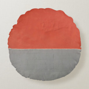 Grijs en oranje geschilderde wand rond kussen