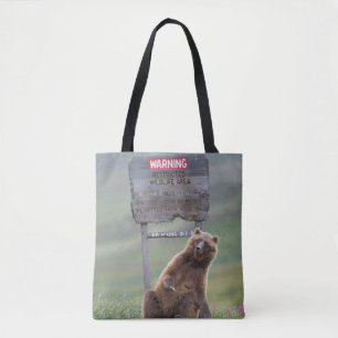 Grijze beer speelt met bord tote bag