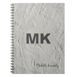 Grijze muur gemerkte professionele moderne notitieboek