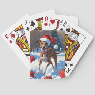 Grijze windhond rent door sneeuw met kerstmuts pokerkaarten