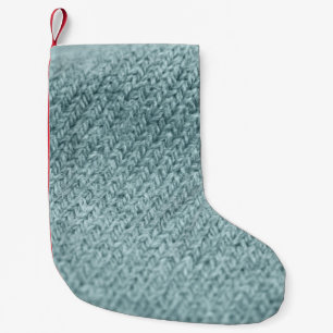 Groen gebreide textuur: trendy achtergrond kleine kerstsok