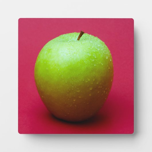 Groene appel op rode achtergrond fotoplaat (Voorkant)