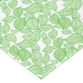 Groene bladeren op witte tablet tafelkleed (Gekanteld)