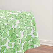 Groene bladeren op witte tablet tafelkleed (Voorbeeld)