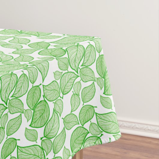 Groene bladeren op witte tablet tafelkleed (Voorbeeld)