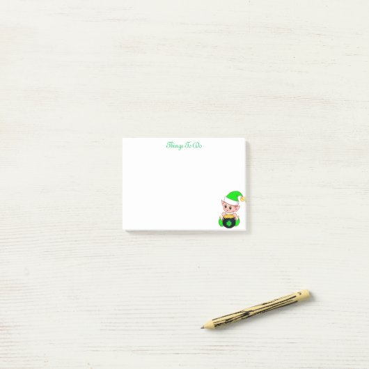 Groene elf & gouden munten op wit post-it® notes (Op bureau)