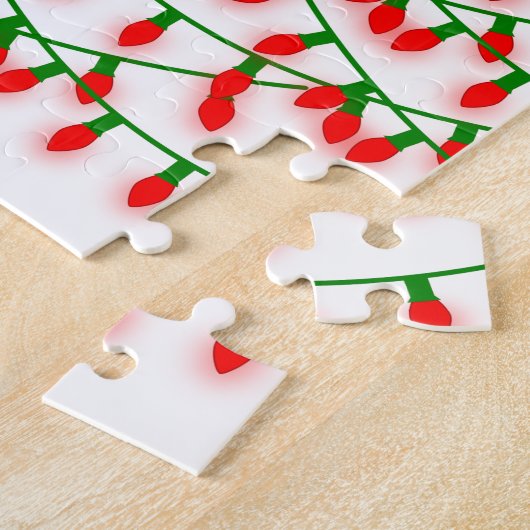Groene en rode kerstlampjes die rustreren legpuzzel (Zijkant)