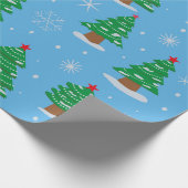 Groene kerstbomen met vallende sneeuw op blauw cadeaupapier (Hoek)