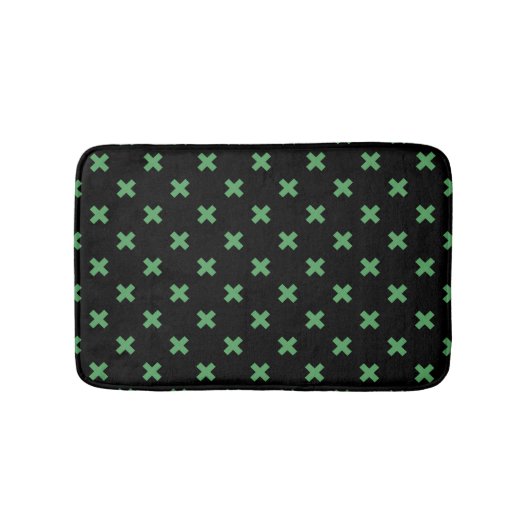 Groene kruisstiften op zwart badmat (Voorkant)