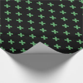 Groene kruisstiften op zwart cadeaupapier (Hoek)