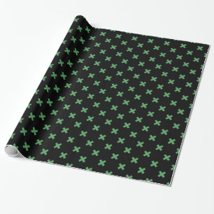 Groene kruisstiften op zwart cadeaupapier