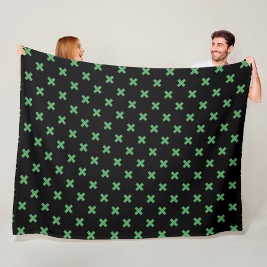 Groene kruisstiften op zwart fleece deken (In situ)