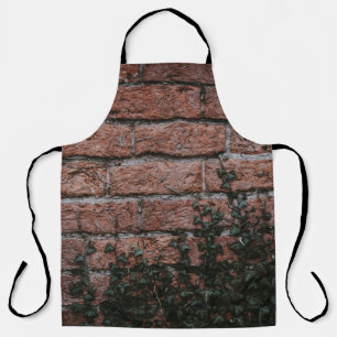 Groene planten nabij baksteenwand schort