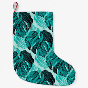 Groene tropische palmbladeren ontwerp. kleine kerstsok