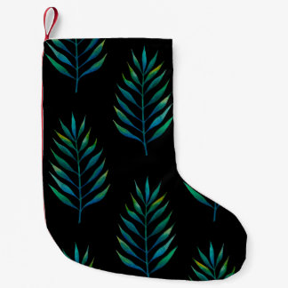 Groene waterverf palmbladeren op een zwarte achter kleine kerstsok