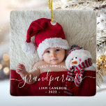 Grootouders Eerste kerstfoto White script Keramisch Ornament<br><div class="desc">Help hen hun eerste kleinkind te vieren met deze mooie moderne keepaardsieraad. In de zwart-wittekst staat "Ons eerste kerstfeest als grootouders" met het woord "grootouders" in elegant handschrift met een bloei voor en na het schrijven. Vervang het afbeelding van het monster gemakkelijk door uw favoriete foto van de nieuwe baby,...</div>