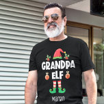 Grootpa elf familie bijpassend kerstcadeaunummer t-shirt<br><div class="desc">Met dit leuke opa elf T-shirt dat deel uitmaakt van een bijpassend collectie dat geschikt is voor huiseigenaars en dat geschenken bevat voor elk familielid. Dit t-shirt is perfect voor elke kerstgezinshereniging en heeft een schattig pet en leuke poten, met de titel "Opa elf" in een wit, modern lettertype met...</div>