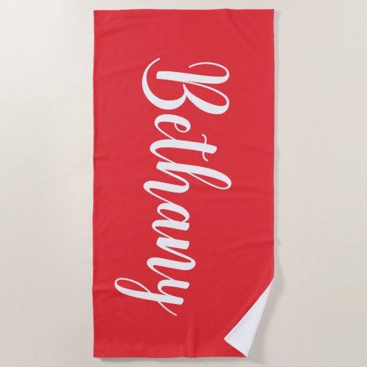 Grote naam in het wit op donkerdieprood strandlaken (Voorkant)