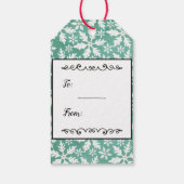 Grote witte sneeuwvlokken die vallen tegen een gro cadeaulabel (Achterkant)