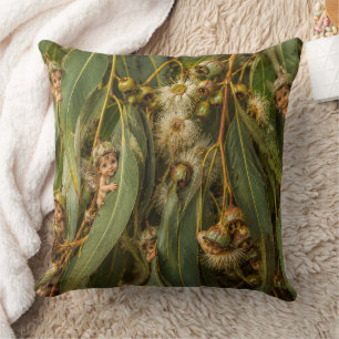 Gumnut-babypjes die achter eucalyptusbladeren glur kussen