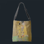 Gustav Klimt The Kiss Crossbody Tas<br><div class="desc">De Kus is het meest iconische en beroemde schilderij van Gustav Klimt. Het is een prachtig gouden schilderij van een paar diep verliefd op het delen van een romantisch moment van een gepassioneerde kus. Profiteer van uw hoogwaardige cadeauideeën en geweldige producten met dit prachtige meesterwerk. Bekijk onze winkel voor meer...</div>