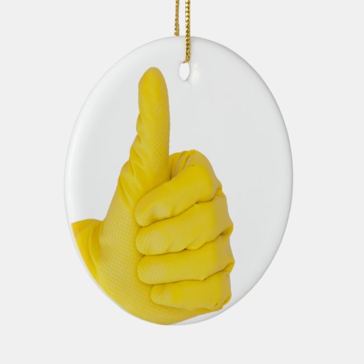 hand in gele latexhandschoen keramisch ornament (Rechts)