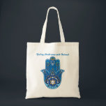 Hand-some Hamsa Tas - aangepaste tekst<br><div class="desc">Deze canvas tas is niet zomaar een tas; het is een statement stuk! Met de iconische hand van Fatima, ook bekend als de Hamsa, is deze tas ontworpen om u bescherming en stijl te bieden. De ingewikkelde blauwe en gele patronen zijn opvallend en vol culturele betekenis. Maar wacht, er is...</div>