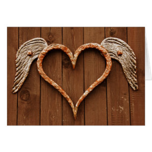 Hart met vleugels tegen roestvrijstalen bordjes