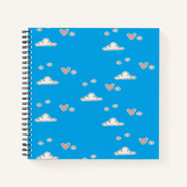 Harten en wolken op blauw notitieboek
