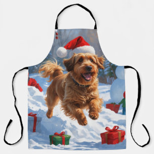 Havanese hardlopen in de sneeuw met kerstmuts schort