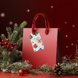 Heldere kerstcadeaudozen & groenblijvende bladeren cadeaulabel